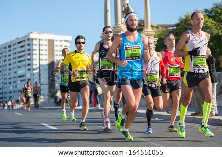 VALENCIA - NOVEMBER 17: Antoni Oliver Rubio (number 267) leads his group during his participation in Valencias marathon on November 17, 2013 in Valencia, Spain