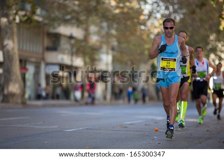 VALENCIA - NOVEMBER 17: Julio Rey de Paz (number 32) leads his group during his participation in Valencias marathon on November 17, 2013 in Valencia, Spain
