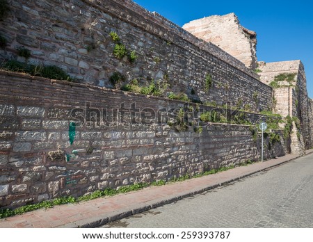 Side view of city walls of Istanbul (Theodosius fortification) and paving road