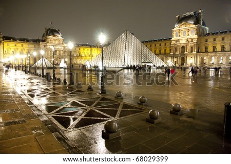 PARIS-APRIL 19: Louvre pyramid at Evening on March 19, 2010 in Paris, France. The Louvre is the biggest Museum in Paris with over 60,000 square meters of exhibition space