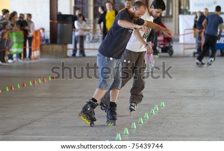 VALENCIA, SPAIN - APRIL 16: Amateur Inline Skaters doing acrobatics with cones in the roller skate exhibition day celebrated each year on April 16, 2011 in Valencia, Spain