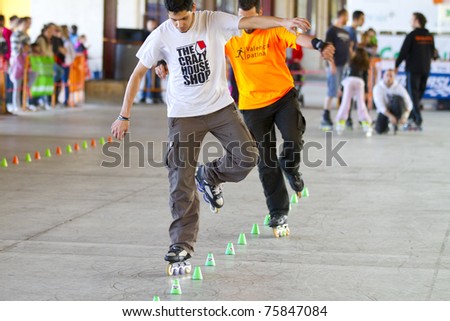 VALENCIA, SPAIN - APRIL 16: Front view of amateur Inline Skaters doing acrobatics with cones in the roller skate exhibition day celebrated each year on April 16, 2011 in Valencia, Spain