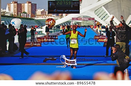 VALENCIA - NOVEMBER 27: kosgei (number 8) winning the mens marathon race at finish line with 2:07:09 time on chrono in Valencias Marathon on November 27, 2011 in Valencia, Spain
