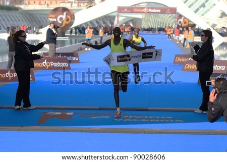 VALENCIA - NOVEMBER 27: kosgei (number 8) winning the mens marathon race at finish line with 2:07:09 time on chrono in Valencias Marathon on November 27, 2011 in Valencia, Spain