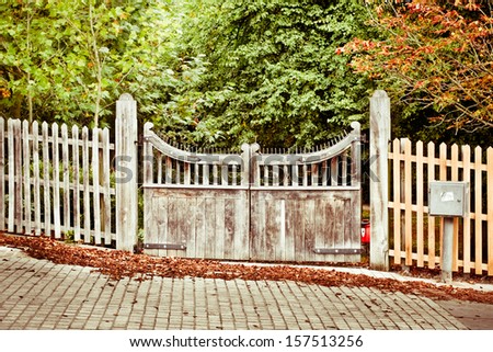 Wooden gate to a forest park with autumn colors