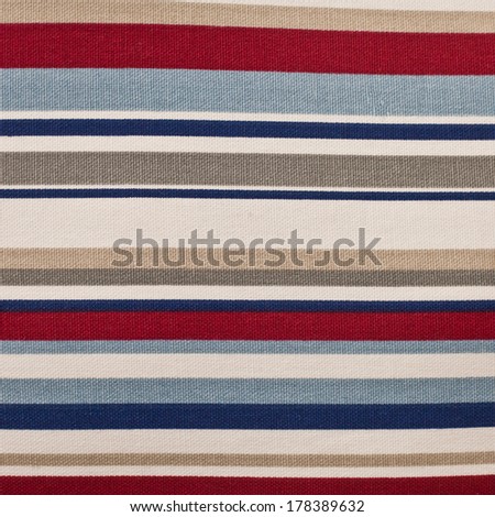 Striped cloth with red, blue, grey, beige and white colors