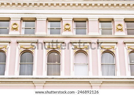 Arch windows in a pink building in the UK