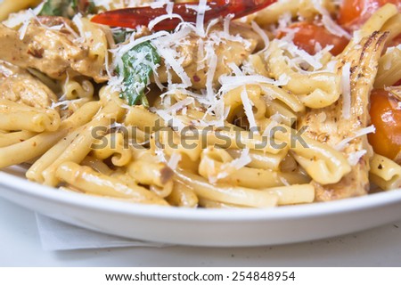 Fresh italian pasta dish with chicken and tomatoes