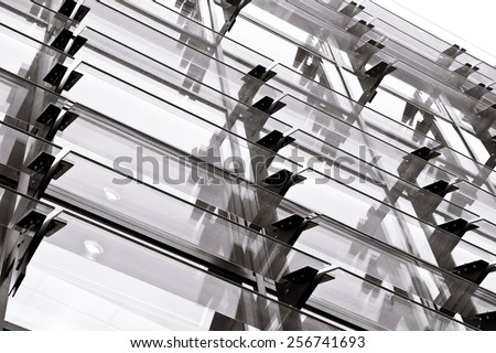 Part of a modern building with glass panels in black and white