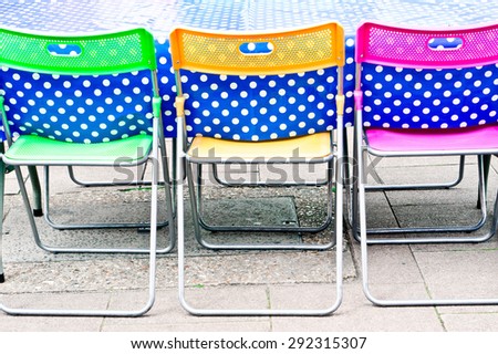 Colorful chairs at a picnic table