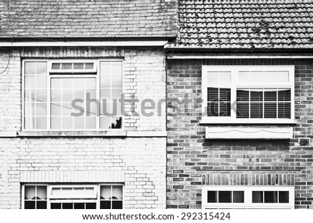Modern double glazed windows in adjoining townhouses in the UK, in black and white tones