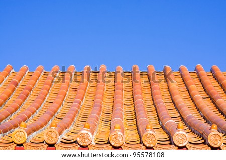 Roof tiles of a chinese building against a bright blue sky