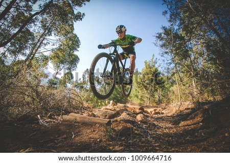 Similar – Image, Stock Photo Cyclist riding bike on rural road in highlands