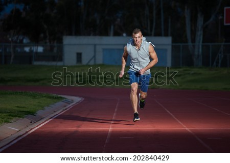 Male fitness model training for sprinting on an athletic track