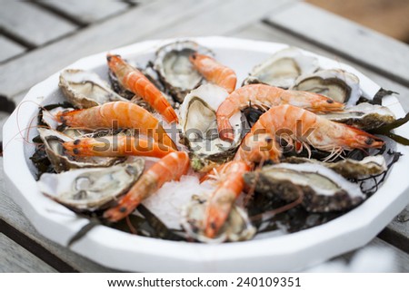 Fresh seafood - Oysters and shrimps on a plate