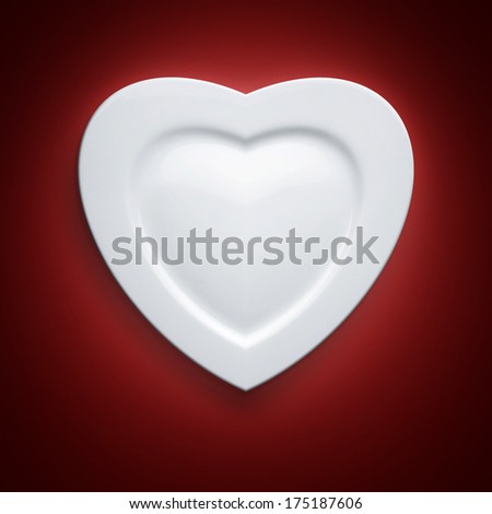 Heart form white plate on red background