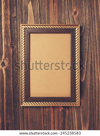 ancient style golden photo image frame on wood background