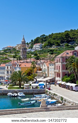 European City Scape. Bay, Boat, Mountain, Sea and Sky. Hvar. Croatia. High quality stock photo.