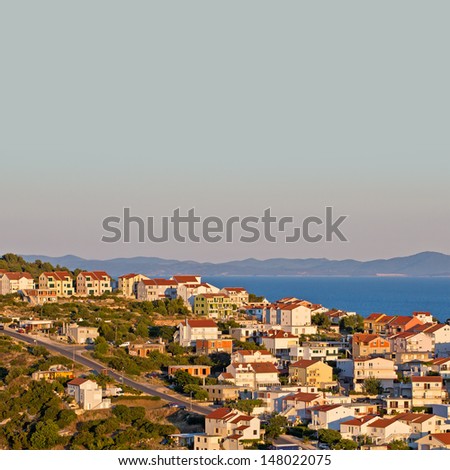 European Southern City Scape. Sea, Bay, Boat, Mountain, Houses, Blue Sky, Resort & Holiday. Hvar. Croatia. High quality stock photo.
