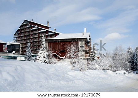 Large mountain cottage under heavy winter