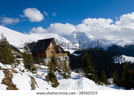 Isolated mountain cottage in winter near the Cirja Peak in Parang Mountains - Romania