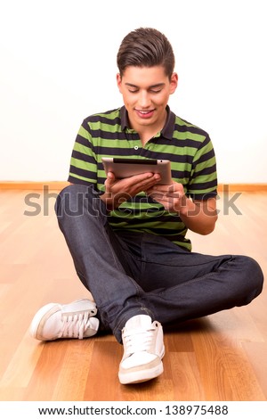 Young  happy student working with a new digital tablet computer