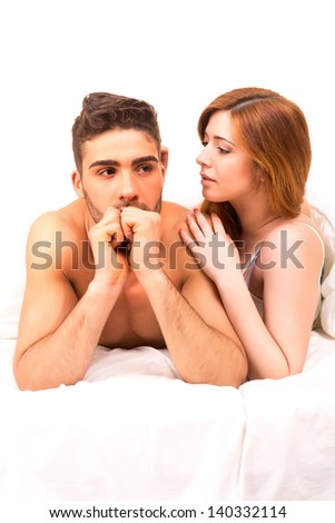 Young depressed couple in bed - daylife problems concept