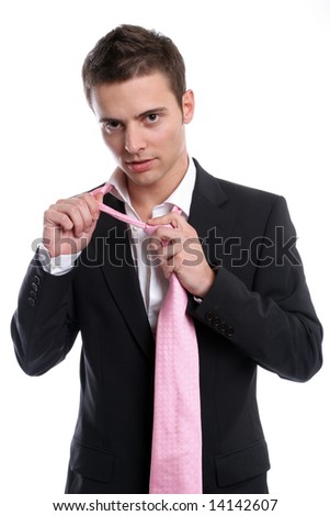Young Business man, fixing his tie, isolated in white background