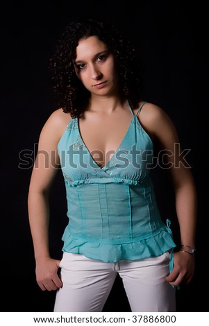 Beautiful woman posing isolated on black - low key shot