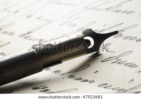 a vintage pen on an old letter