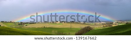 Panorama of a rainbow over the Tuscany hills