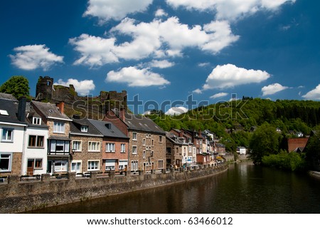 Traditional european houses in Ardennes on a bank of a river