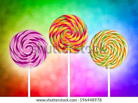 three lolly pops in front of colorful background