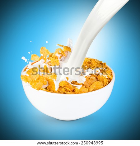 milk splashes into corn flakes bowl