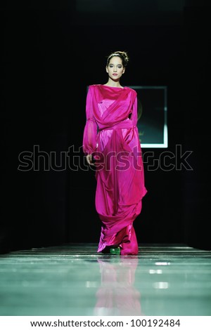 beautiful young fashion model woman walking on  show event