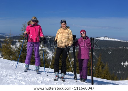 happy friends group of woman girls have fun at winter season at beautiful sunny  snow day with blue sky in background