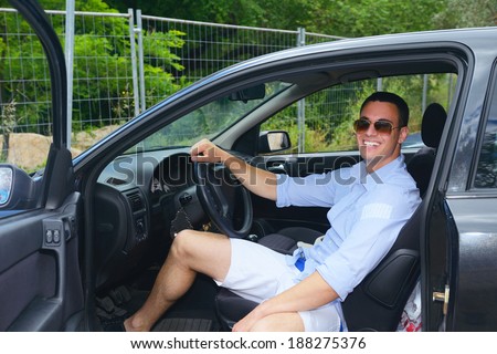 young man car driver changing clothes in car