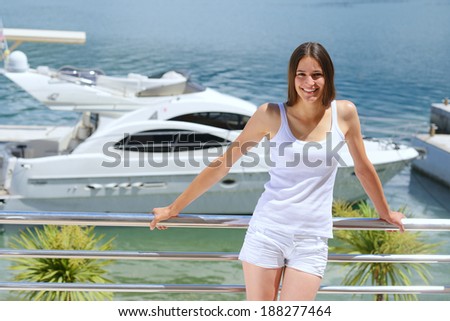 woman lies on a luxury yacht in the sea and looking to the horizon