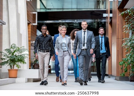young multi ethnic business people group walking