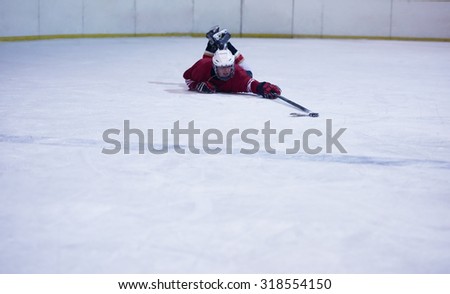 young ice hockey player portrait on training in black background