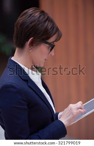 corporate business woman working on tablet computer  at modern office interior