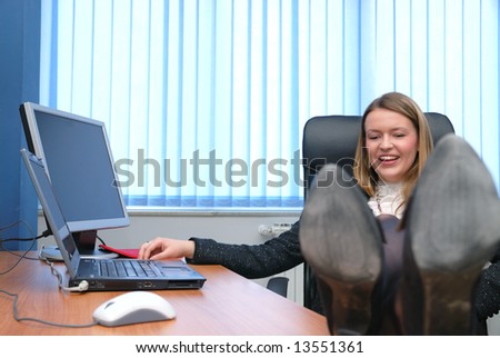 .young business woman relaxing with feet on table