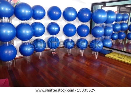 fitness club indoor with blue pilates balls in background
