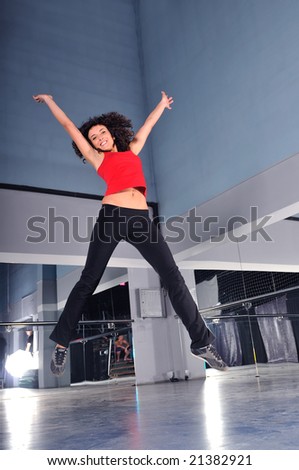 young woman jump in air in fitness studio