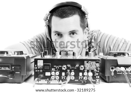 young dj man with headphones and compact disc dj equipment