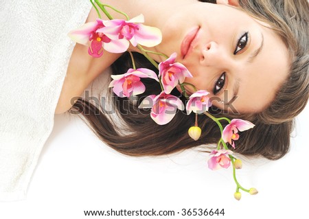 one  beautiful young  woman face with flower and towel
