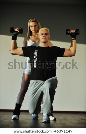 fitness personal trainer in fitness club exercise with client