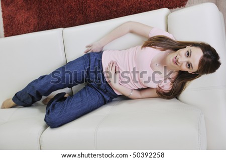 beautiful young woman relaxing on sofa at home