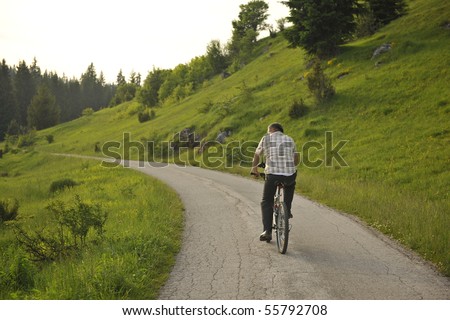senor mature mman ride bike outdoor in nature