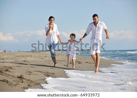 Happy Young Family In White Clothing Have Fun At Vacations On Beautiful